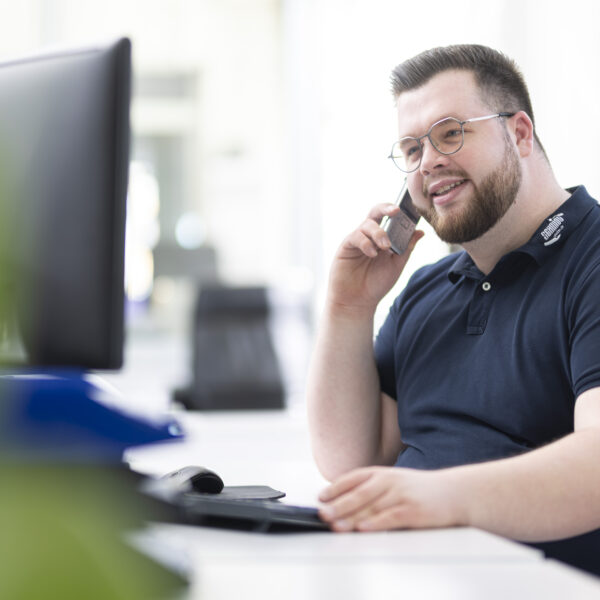 guy with glasses speaking on the phone
