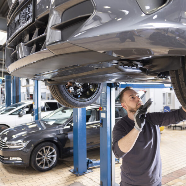 man in the garage checking brakes